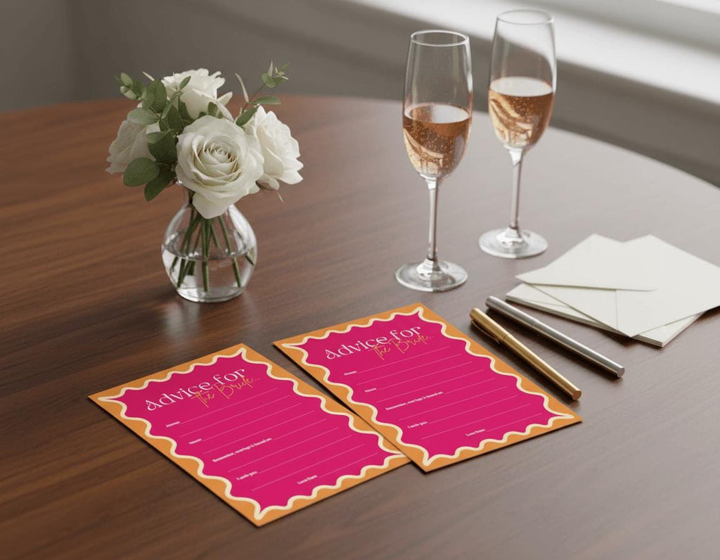 Two glasses of champagne, a vase of white roses, and pink 'Advice for the bride' cards on a table.