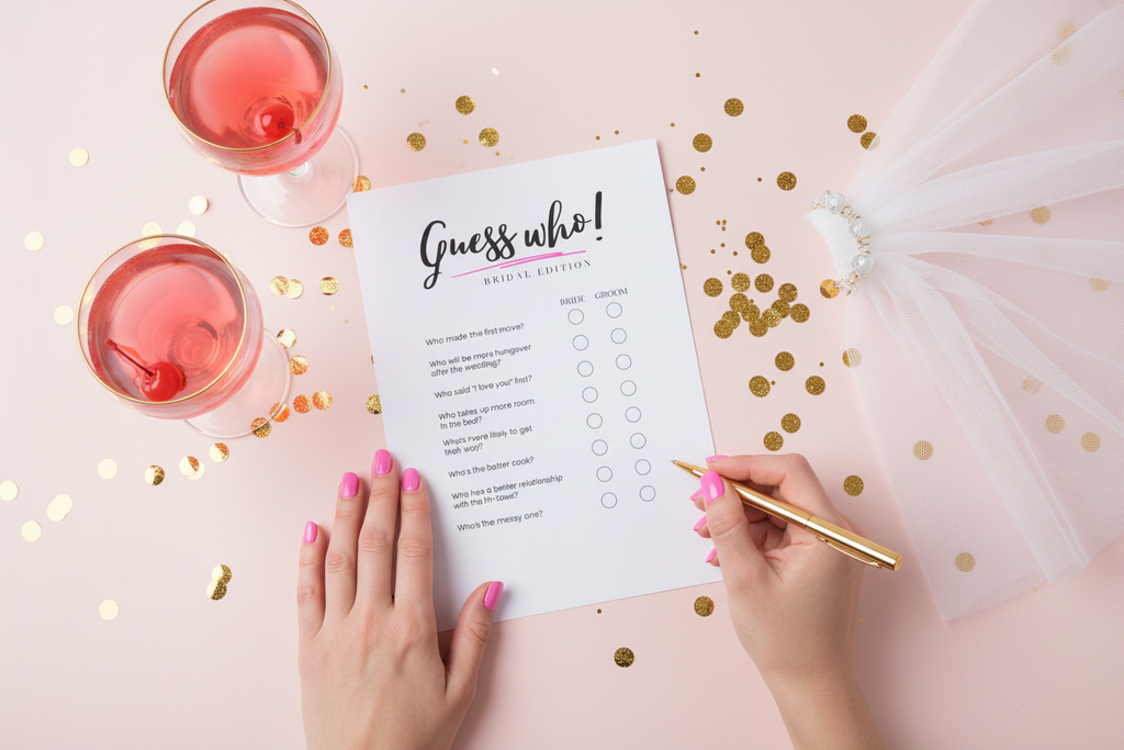 One 'Guess who' bridal shower game sheet on a pink table with two hands  and confetti.
